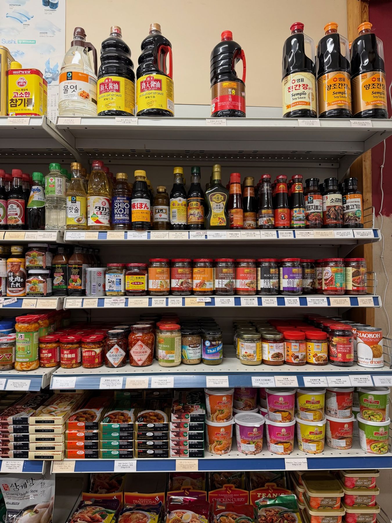 Wall of soy sauce, cooking wine and Asian condiment bottles
